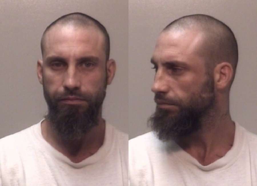 Manhunt suspect found hidden inside wall